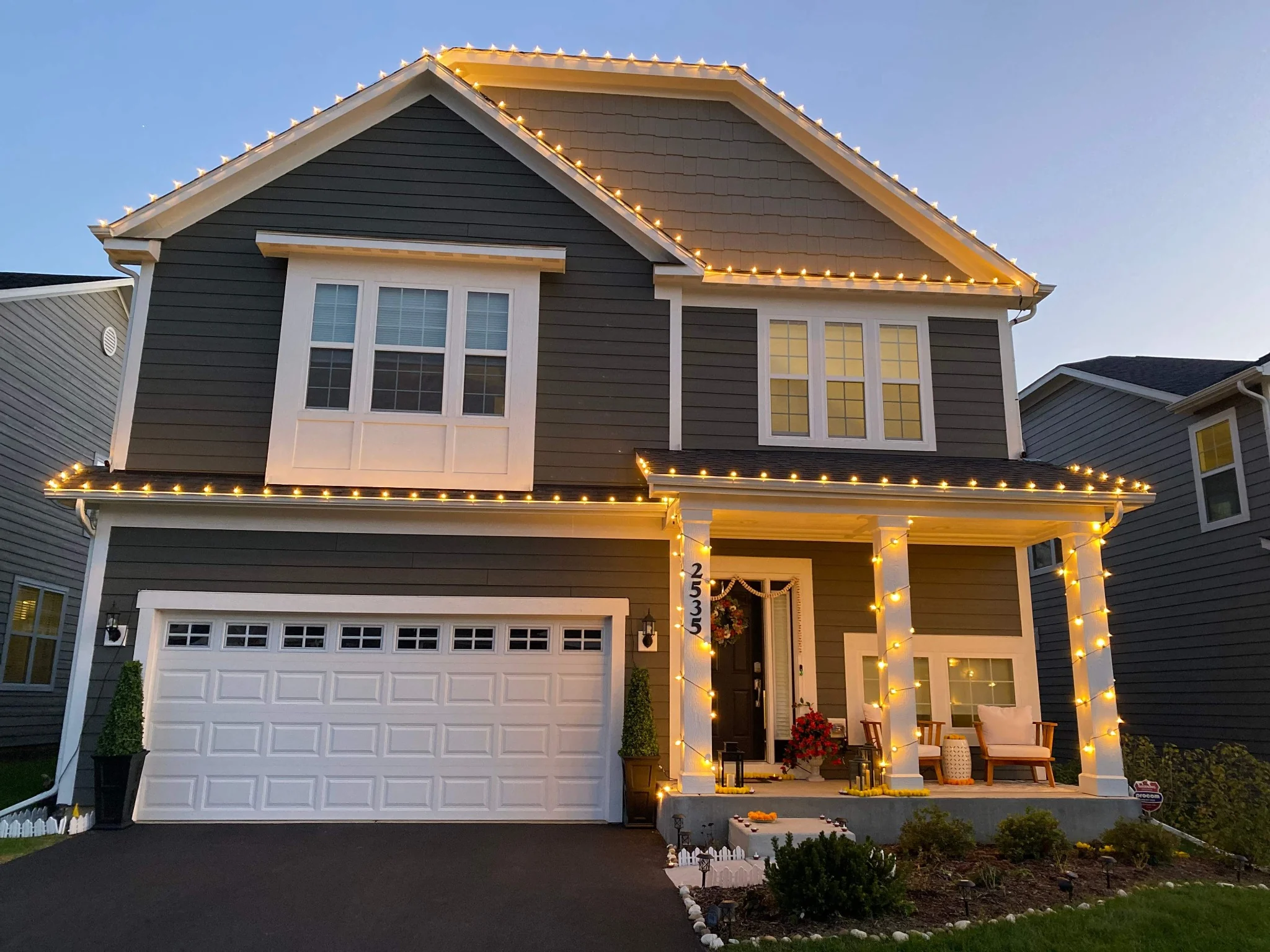 Warm white Christmas lights installed along a home's roofline