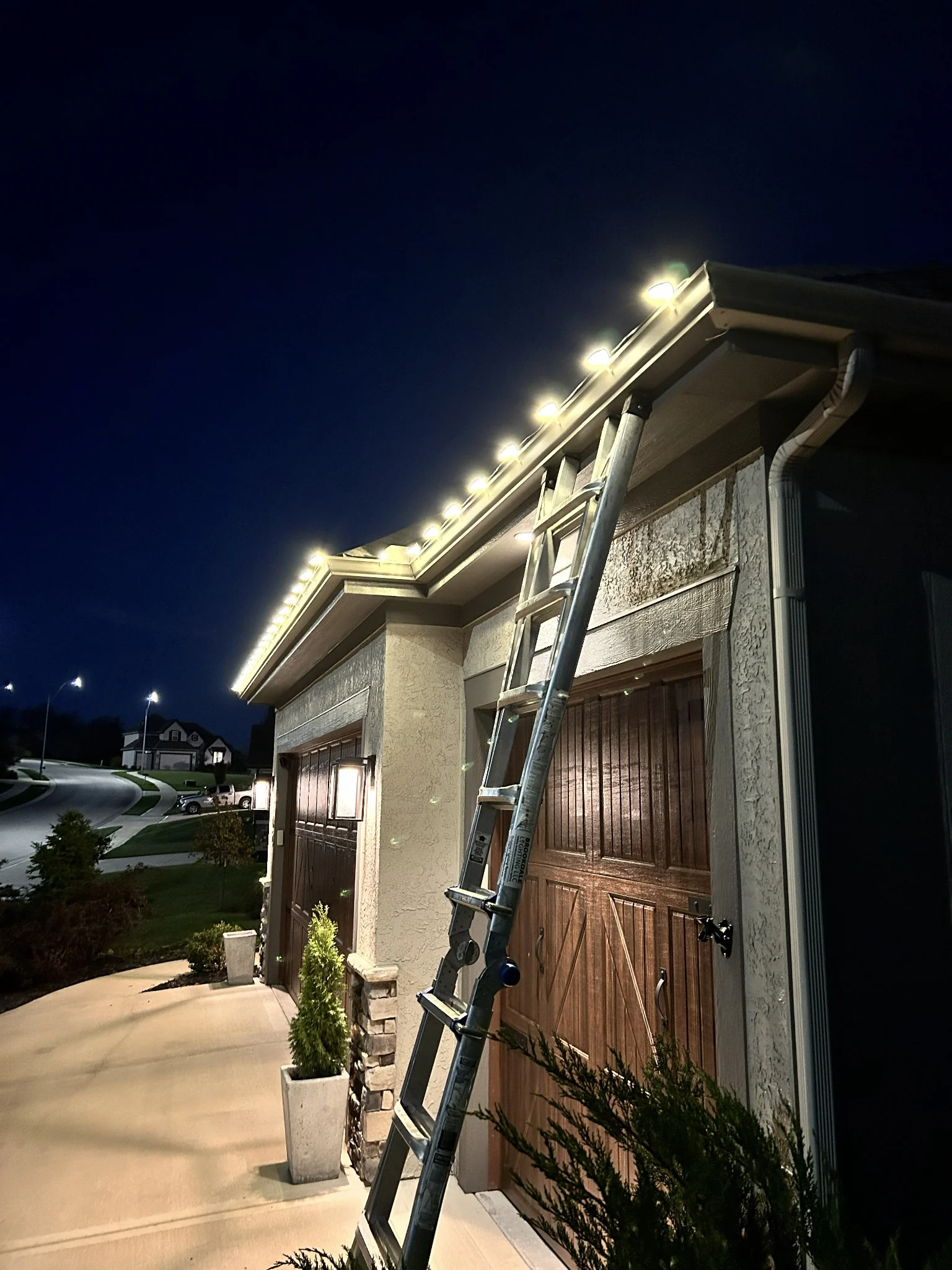 Close-up of exterior roofline lighting installation in progress